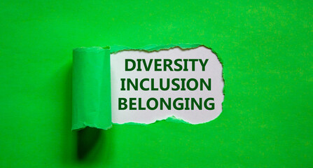 Inclusion and belonging symbol. Words 'diversity, inclusion, belonging' appearing behind torn green paper. Beautiful green background. Business and better inclusion and belonging concept. Copy space.