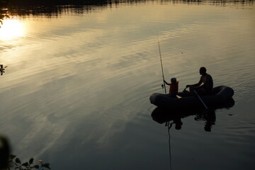 fishermen on the lake in summer
