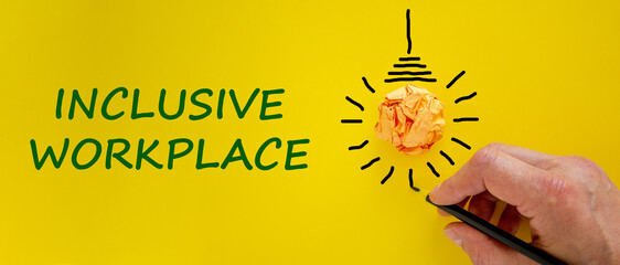 Inclusive workplace symbol. Businessman writing words 'Inclusive workplace', yellow background....
