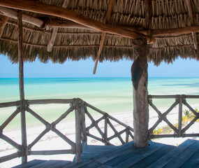 Fototapeta premium Aerial panoramic view of the lagoon on Holbox Island in Mexico, from a rustic wooden tower with a thatched roof. Concept travel tourism