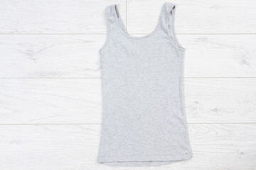 Blank grey Tank Top fold Shirt Mock-up for man on wooden background, tank mock up