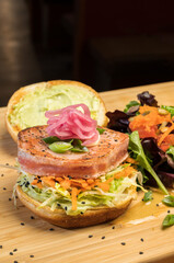 Asian tuna Sandwich at a diner.  Grilled yellowfin tuna, Citrus slaw, Asian tzatziki, and pickled onion.