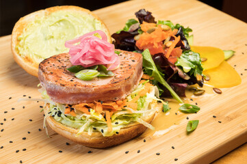 Asian tuna Sandwich at a diner.  Grilled yellowfin tuna, Citrus slaw, Asian tzatziki, and pickled onion.