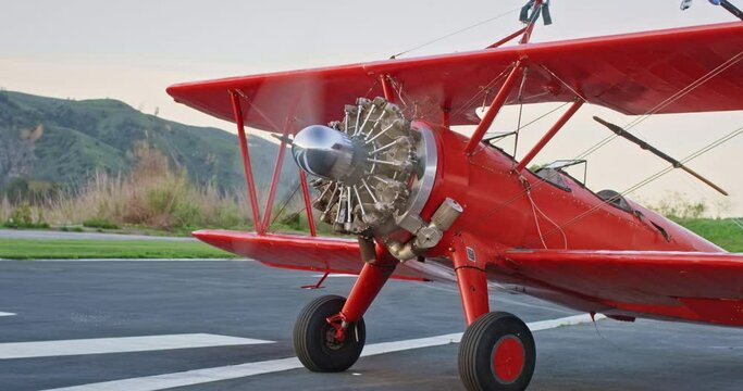 Medium shot, spinning propeller of vintage plane on runway