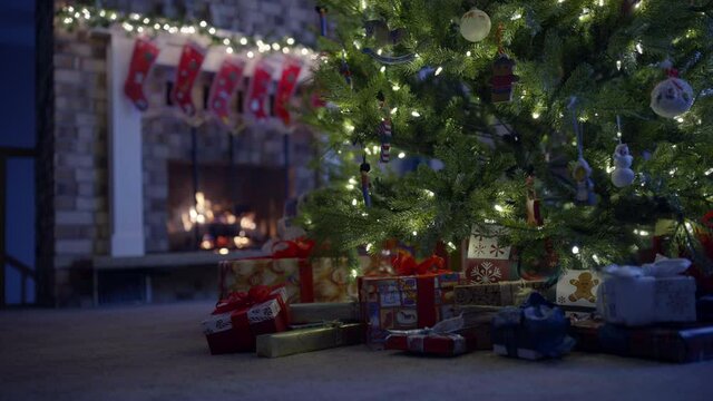 Low angle, Christmas presents under tree near fireplace
