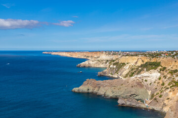 Naklejka na ściany i meble Cape Fiolent in Crimea. Beautiful views of the Black Sea coast at Cape Fiolent in summer. Sea coast with turquoise water and rocks