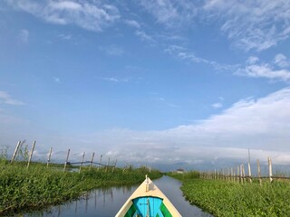 Inle Lake, Myanmar - November 9, 2019: Boat navigating through floating gardens in Inle Lake