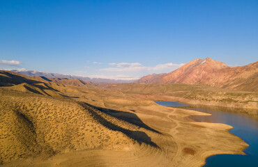 Panoramic aerial view on the  lake and mountains at the bright sunny day. Beautiful landscape.