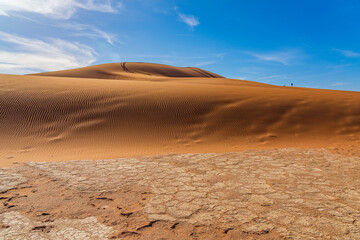 On the way to Deadvlei Ssossusvlei surrounded by great dunes. Red sand. Panoramic view.