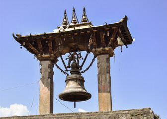 Close-up of a big bell in Kathmandu Durbar Square in contrast with the blue sky. Nepal.