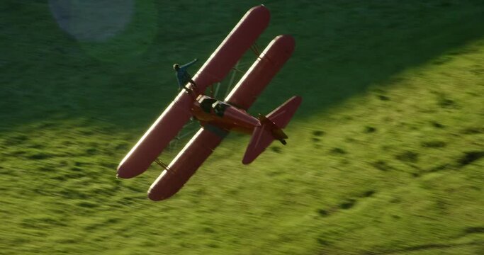 Aerial, stuntman on top of vintage planes fliers over countryside