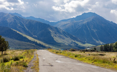 View of an old paved road in a mountainous area in Central Asia.