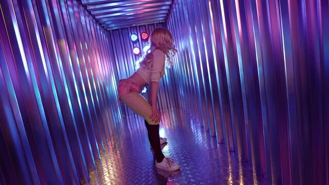 blonde stripper is dancing in nightclub, moving sexually, shaking her buttocks, twerking