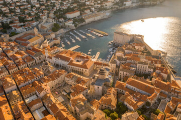 Aerial drone shot of Dubrovnik old town port in sunrise sun light in Croatia summer