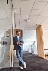 Fototapeta premium Happy adult caucasian man is working in a modern office