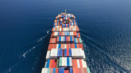 Fototapeta premium Aerial drone photo of container cargo ship in import export business commercial trade logistic and transportation in the open sea, Container cargo freight shipping.
