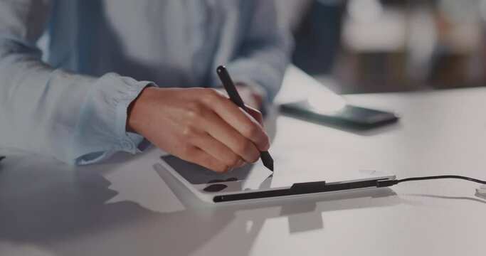 Hands of black young woman graphic designer making a creative art project on digital design tablet notepad staying home. Hobby activity. Freelance work.