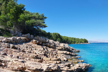WIld pine forest along Hvar island, coastline of Adriatic Sea. Maslinica Beach, Public bathing...