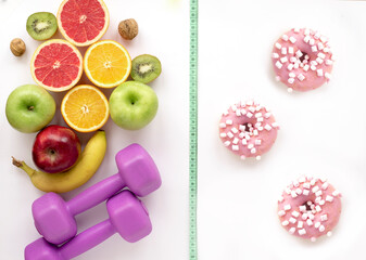 A centimeter border between tempting sweet and healthy food, sports