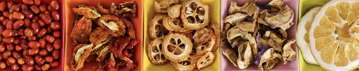Colorful bowls with dehydrated food. Different dry vegetables and fruits flat lay banner.