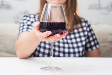 A woman with glass red wine. A woman is drinking red wine