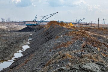 Rudny/Kazakhstan - May 14 2012:  Walking dragline excavators removing empty rocks in quarry.  Extraction iron ore by Open-pit mining