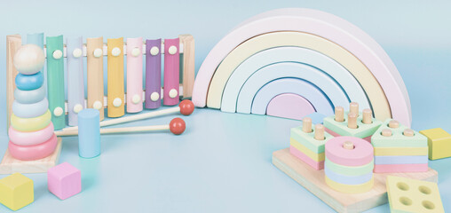 Kids toys collection. Wooden rainbow, educational and music baby toys on light blue background