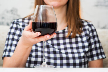 A woman with glass red wine. A woman is drinking red wine