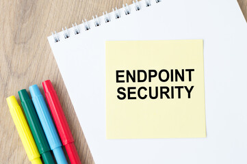 text writing Endpoint Security. Concept meaning the methodology of protecting the corporate network. On the table is a notebook with a yellow card for notes and colored markers