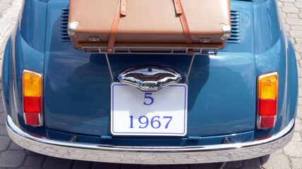  Old vintage car in mint condition with suitcase ready for travel