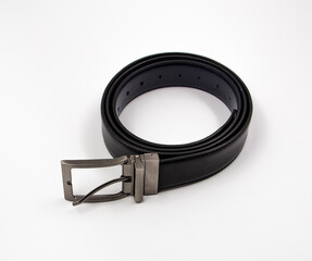 Obraz premium Black belt for pants, on a white background.