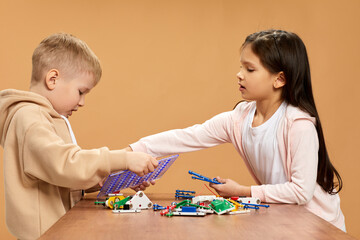 cute children playing with electronic constructor at studio