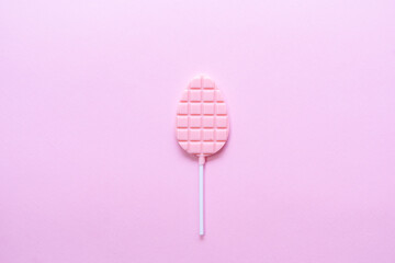 Minimalism colorful concept of chocolate pops on pink background. Flat lay. Copy space.