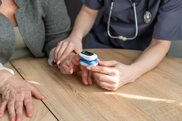 Medic and patient using finger pulse oximeter