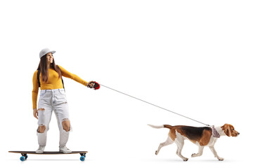 Full length shot of a female skater riding a longboard with a dog on a lead
