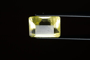 Natural gem yellow citrine on a black background