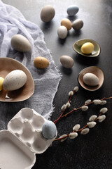 Colourful pastel easter eggs in the nest on a dark background with rustic kitchen decor