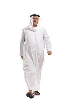 Full length portrait of a cheerful mature arab man walking towards camera