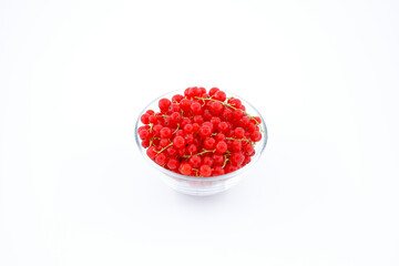 Red currants in a plate on a white background. Side view, horizontal frame.