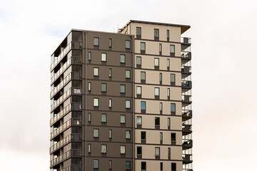 Ten storey high grey apartment building.