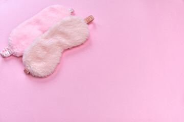 Fototapeta na wymiar Pink sleeping mask on the pink background