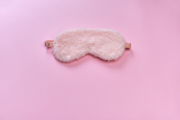 Pink sleeping mask on the pink background