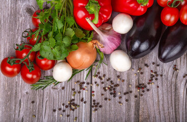 heap of bright ripe vegetables on grey table