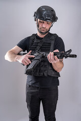 Man equipped for airsoft is looking as his weapon