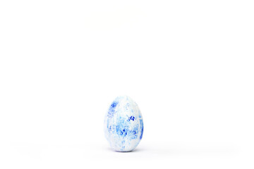 Happy Easter. One easter egg trendy colored classic blue, white and golden on white. Copy space....