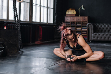 Obraz na płótnie Canvas Young girl doing sports in the gym. Atmospheric gym