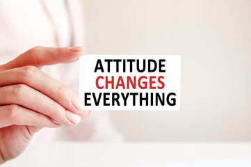 attitude changes everything written on a paper card in woman hand