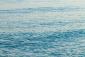 Sea water blue surface with ripples. Abstraction.