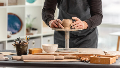 Man using pottery wheel for molding