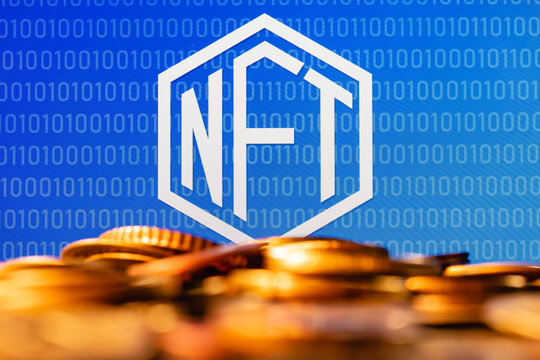 A NFT (non-fungible token) is a special cryptographically-generated token that uses blockchain technology to link with a unique digital asset. NFT symbol with coins in the foreground.
